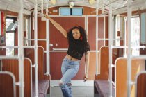 Fröhliche hispanische Frau in Berliner Eisenbahnwaggon blickt in die Kamera — Stockfoto