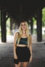 Beautiful blonde salope model smiling and looking at camera in Berlin on blurred background looking at camera — Photo de stock