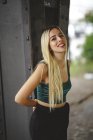 Beautiful blonde salope model smiling and looking at camera in Berlin on blurred background looking at camera — Photo de stock