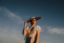Beautiful stately woman in hats in bright sunny day — Stock Photo