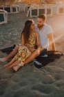 Young people in love bonding in seaside in romantic sunset evening — Stock Photo