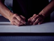 Hands of bookbinder making markup with pencil on page — Stock Photo