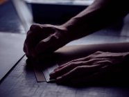 Hands of bookbinder making markup with pencil on page — Stock Photo