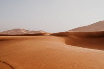 Hill from dry sand in middle of large desert against gray sky in Morocco — Stock Photo