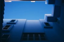 From below geometric windows in passage of building — Stock Photo