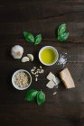 Ingredients for pesto pasta arranged on wooden table, top view — Stock Photo