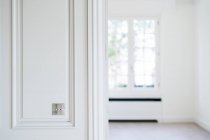 Metal switch on white wall in room with trendy minimalist interior - foto de stock