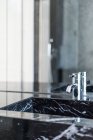 Rectangular washbasin and shiny steel faucet in luxurious bathroom in daylight - foto de stock