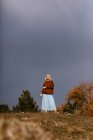 Beautiful blonde walking along autumn countryside — Stock Photo