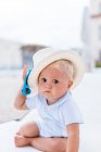 Frontalansicht eines blonden Babys mit Hut am Strand — Stockfoto
