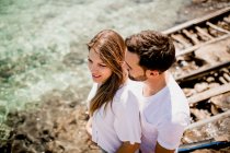 Happy lovers cuddling at cove — Stock Photo