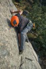 From above man climbing a rock in nature with climbing equipment — Stock Photo