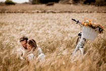 Lovers embracing on wheat field — Stock Photo