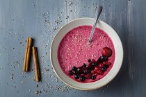 Smoothie bowl with fresh berries and sesame served on table — Stock Photo