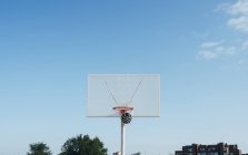 Ball into net basket in outdoor basketball court. — Stock Photo
