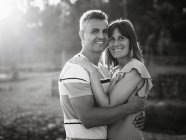 Casal olhando na câmera com sorriso feliz ao ar livre — Fotografia de Stock