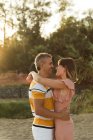 Couple looking at each other with happy smile in backlit — Stock Photo