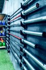 Set of barbells fixed to wall in contemporary health club — Stock Photo