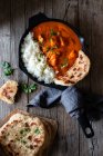 Close up of skillet full of delicious butter chicken and rice — Stock Photo