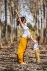 Pregnant mother and little daughter having fun in park — Stock Photo