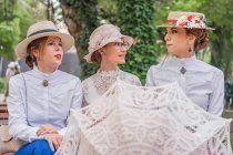 Old fashioned ladies talking in park — Stock Photo
