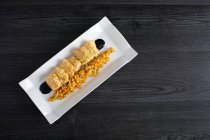 Meat breaded with matignon in white rectangular plate — Stock Photo