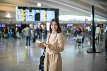 Femme utilisant un smartphone à l'aéroport — Photo de stock