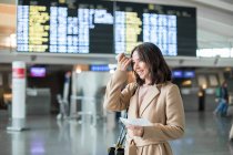Woman standing in airport — Stock Photo