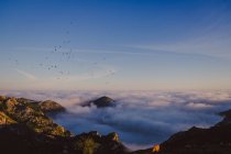 Wonderful view of blue sky above white thick clouds in valley from mountain — Stock Photo