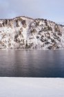 Breiter sibirischer Fluss und verschneite Berge — Stockfoto