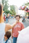 Cheerful kids enjoying sweet candyfloss on street — Stock Photo