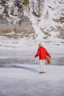 Frau beim Schlittschuhlaufen auf gefrorenem Fluss — Stockfoto