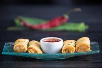 Vietnamese rolls with sweet chili on glass plate — Stock Photo