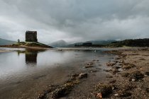 Ancient building placed on small island near mountains in Scotland — Stock Photo