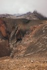 Rocky terrain with misty and cloudy sky in Tongariro in New Zealand — Stock Photo