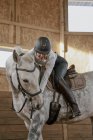 Rider riding dapple gray horse in round arena — Stock Photo