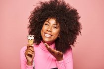 Funny woman with ice cream on stick looking at camera — Stock Photo