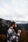Homme jouissant d'une vue sur la forêt et les montagnes — Photo de stock