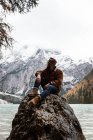Man delighting in views near lake and mountains — Stock Photo