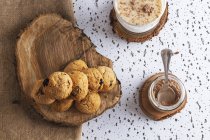 Composition of organic homemade cookies with jar of cacao powder and glass of tasty cacao drink — Stock Photo