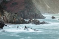 Picturesque majestic raging waters of bay breaking rocks on beach of Silence O Gaviero in Spain — Stock Photo