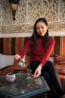 Asian woman enjoying Arabic tea — Stock Photo