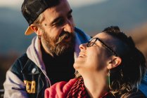Смеющиеся счастливые пары смотрят друг на друга в солнечную погоду — стоковое фото