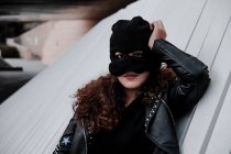 Woman in balaclava and black leather jacket — Stock Photo