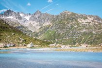 Serene landscape of rocky mountains and calm shore with impeccable water in Switzerland — Stock Photo