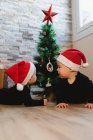 Happy babies near Christmas tree and gifts — Stock Photo