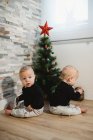 Happy babies near Christmas tree and gifts — Stock Photo