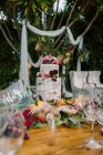 Wedding table decoration in rustic style placed outdoors — Stock Photo