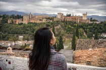 Touristin genießt Blick auf große antike Burg in Granada, Spanien — Stockfoto