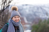 Asian female tourist in warm clothing at snowy nature — Stock Photo